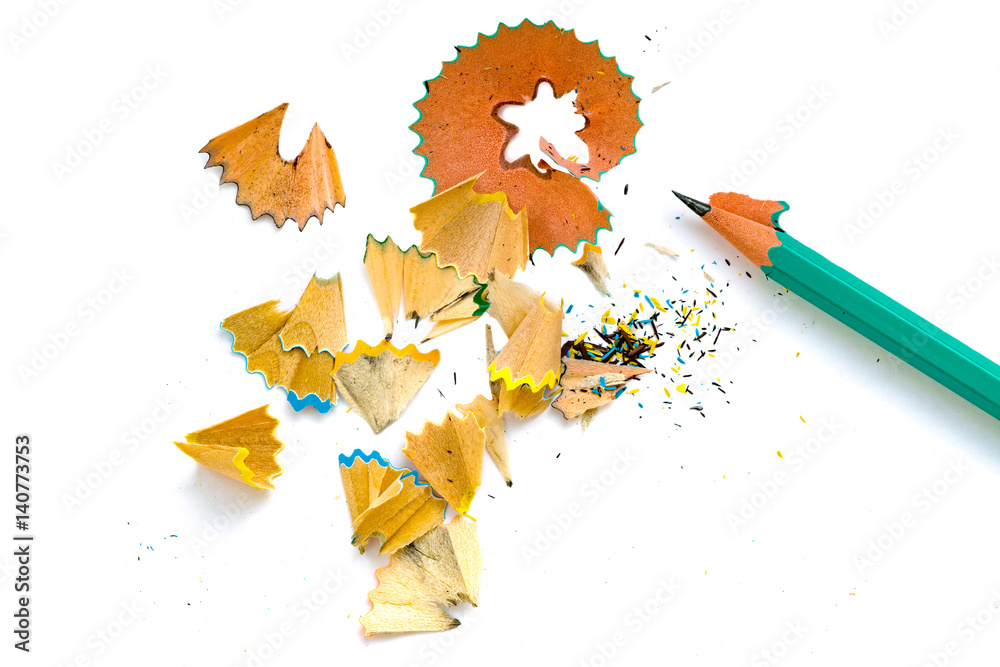 A simple sharpened pencil with peelings on a white background closeup A simple sharpened pencil with peelings on a white background closeup