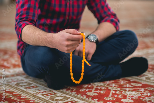 Muslim reciting silently on praying beads