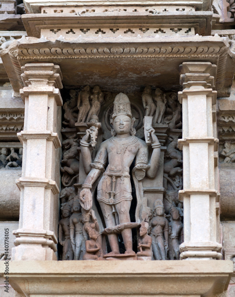 Ancient statue of Shiva God at the facade of temple in Khajuraho, India