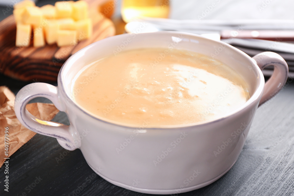 Delicious cream soup in pan on table Delicious cream soup in pan on table