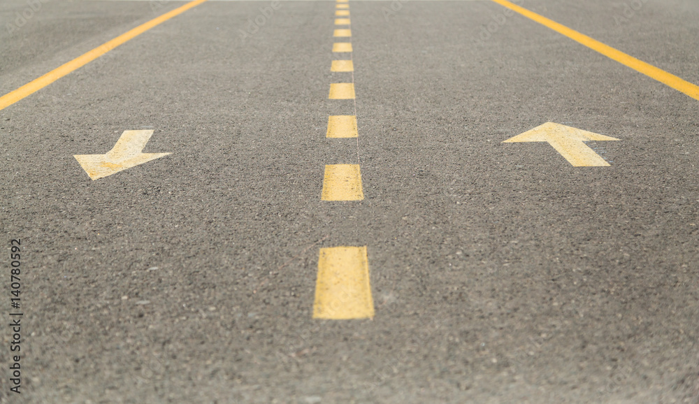 Yellow marking on the pavement.