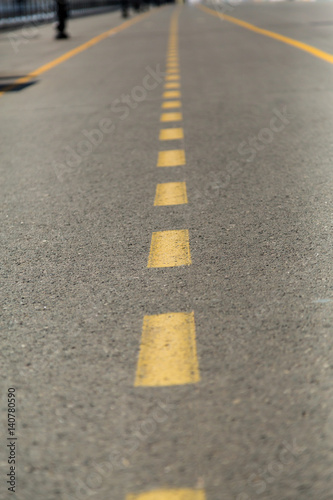 Yellow marking on the pavement.