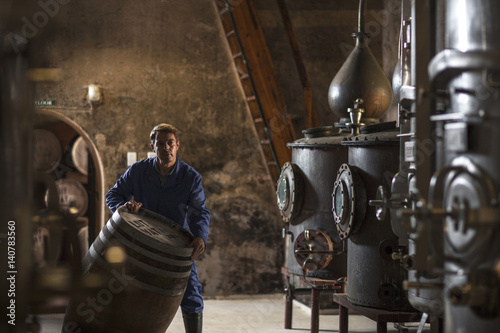 Worker working in distillery photo