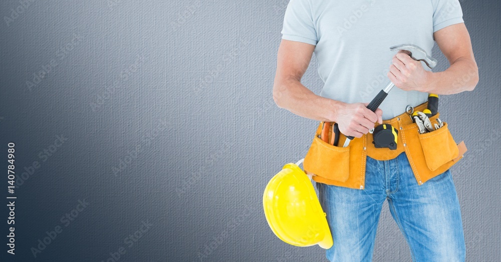 Composite image of Carpenter with hammer against navy background Composite image of Carpenter with hammer against navy background