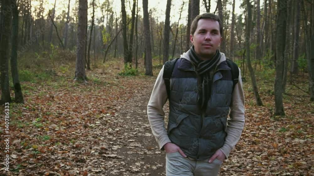 Young man walking in the autumn forest. Young man walking in the autumn forest.