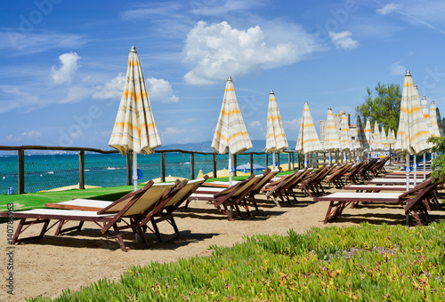 Beach chairs and umbrellas in summer season