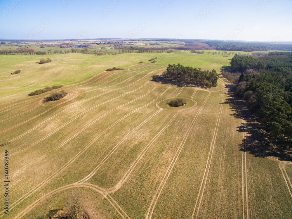 Obraz premium Aerial view of agricultural fields in spring with blue sky - germany