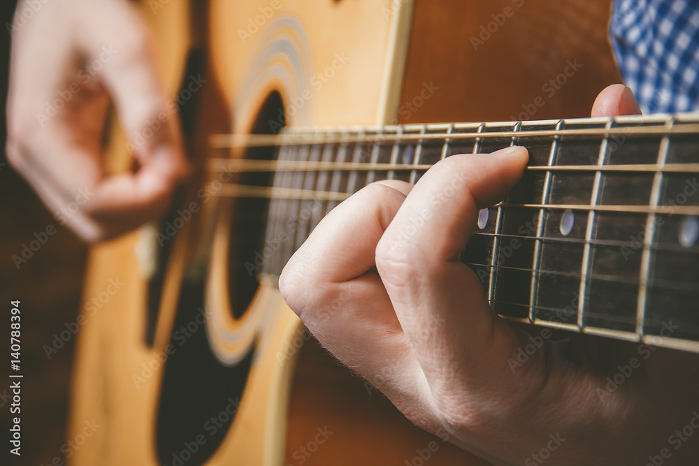 Fototapeta premium Close up of guitarist hand playing guitar