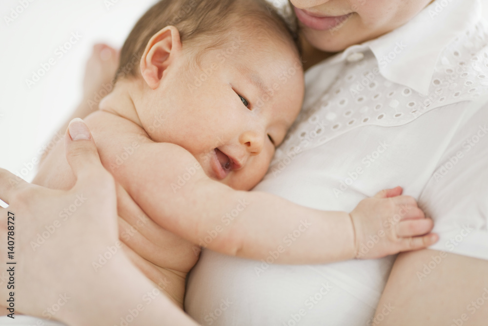 Close-up of mother holding her baby boy in her arms Close-up of mother holding her baby boy in her arms