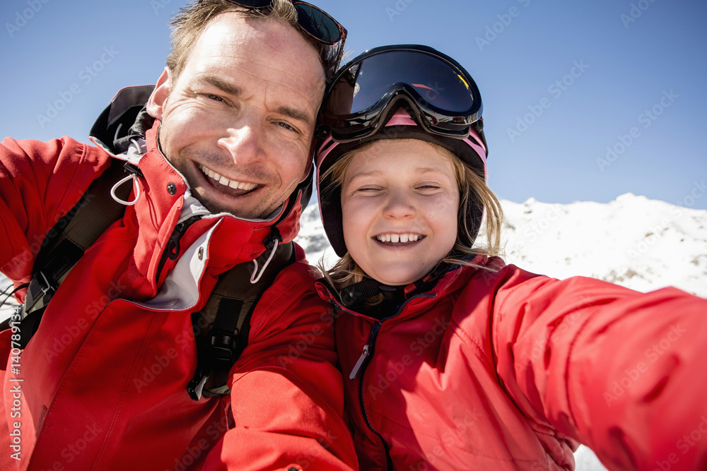 Portrait of cheerful father and daughter in warm clothing Portrait of cheerful father and daughter in warm clothing