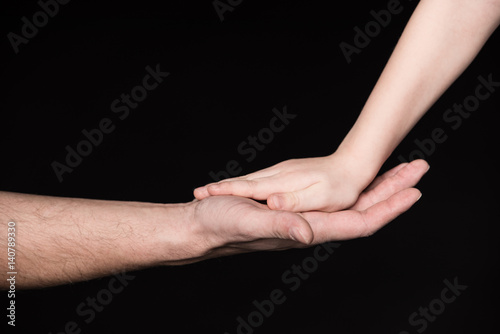 Father and child touching palms