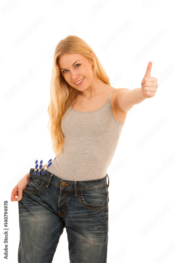 Young happy woman gestures success as she lost a lot of weight Young happy woman gestures success as she lost a lot of weight