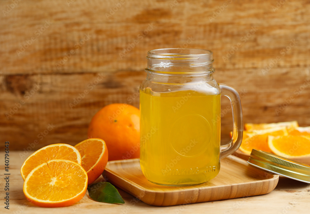 Orange juice and oranges on retro wooden desk Orange juice and oranges on retro wooden desk