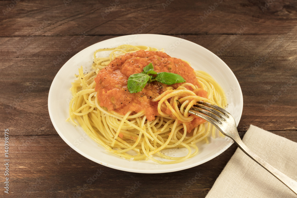 Plate of spaghetti with tomato sauce and copyspace