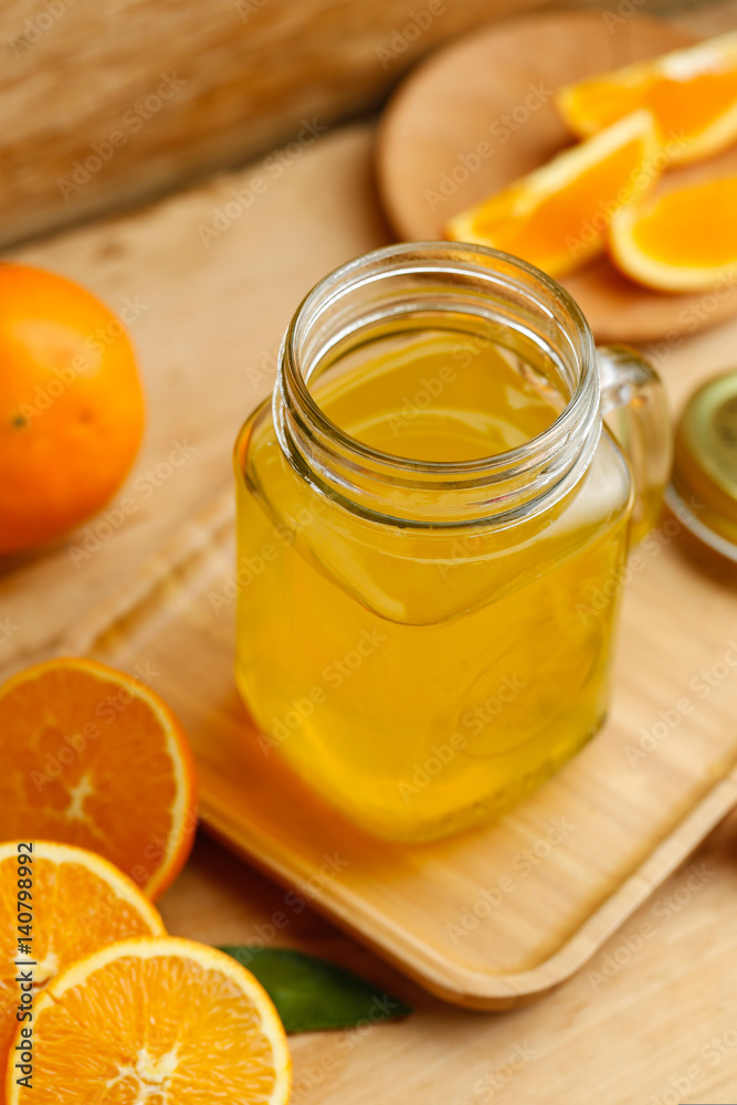 Orange juice and oranges on retro wooden desk Orange juice and oranges on retro wooden desk