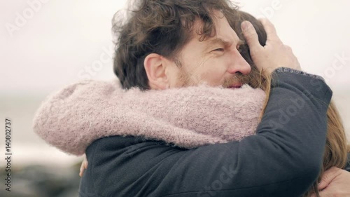 Handsome man crying hugging love of his life