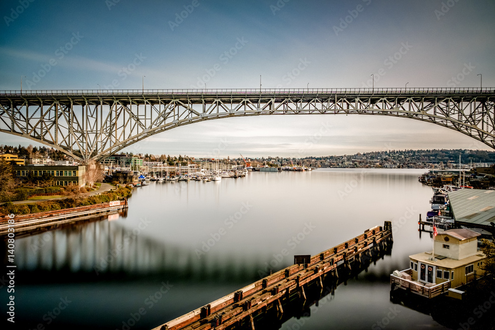 Reflective day on Lake Union with the Aurora Bridge and houseboat