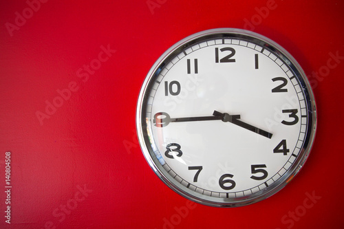 modern big clock on red wall