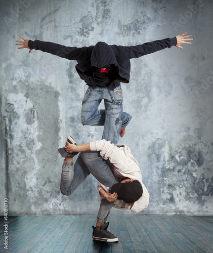 Two man break dancing on wall background