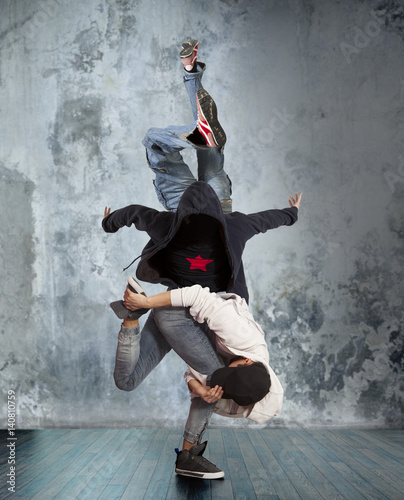 Two man break dancing on wall background