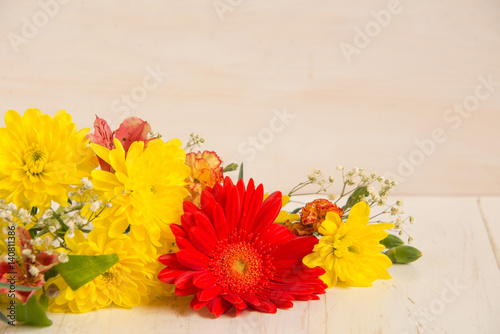 Composition of bright flowers on a wooden table