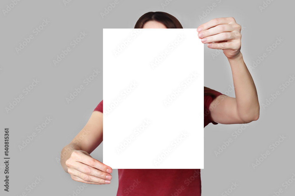a sheet of paper in his hand, on a background a sheet of paper in his hand, on a background