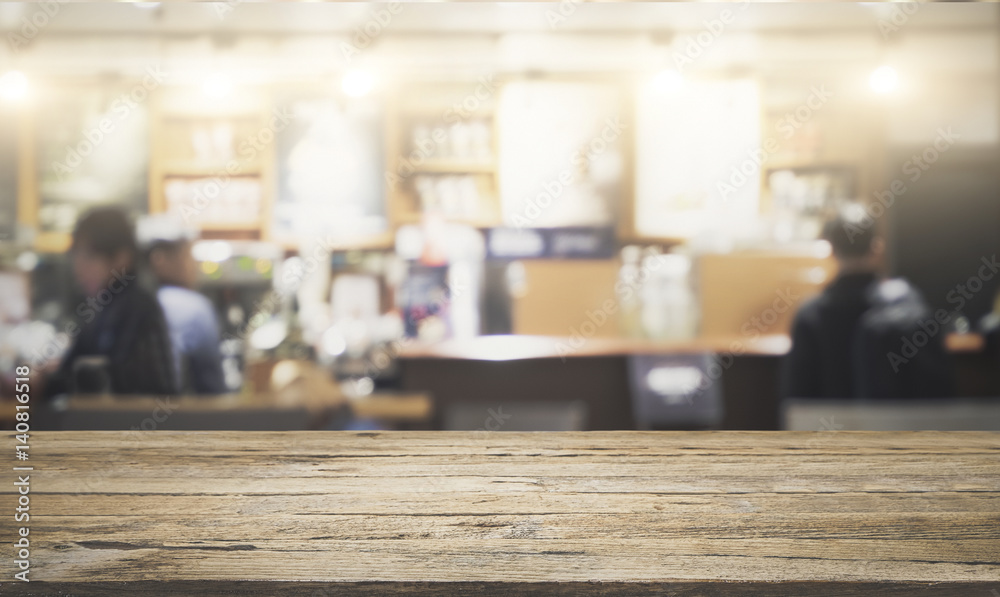 Empty wooden table for present product on coffee shop blur background with bokeh image.