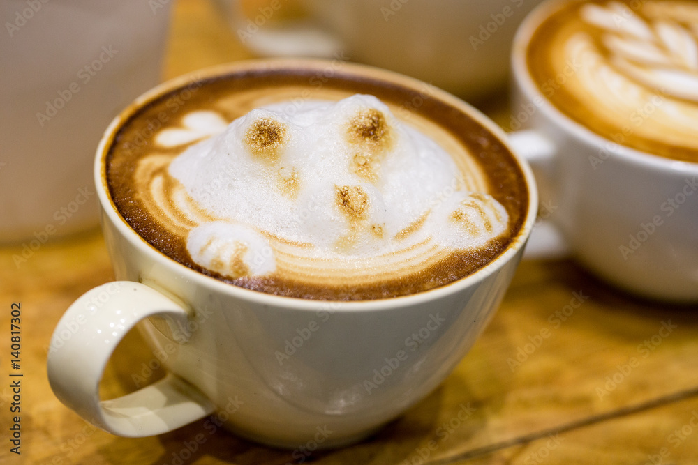 art latte on a cappuccino coffe cup