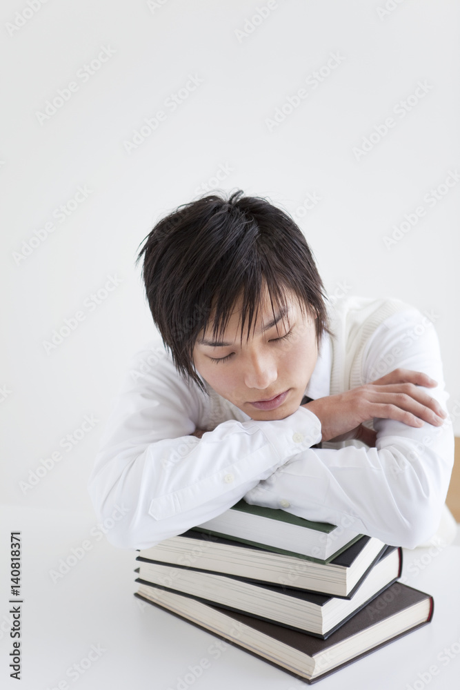 High School Student Resting on Pile of Books High School Student Resting on Pile of Books