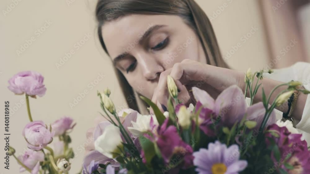 Florist making bouquet. Florist at work: pretty young woman making fashion modern bouquet of different flowers. Florist. Flower shop. The process of creating a floral composition. Flower composition. Florist making bouquet. Florist at work: pretty young woman making fashion modern bouquet of different flowers. Florist. Flower shop. The process of creating a floral composition. Flower composition.