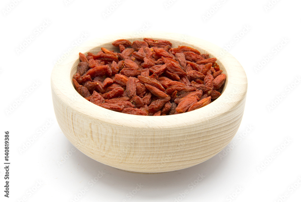 Dried Goji berries in wooden bowl Dried Goji berries in wooden bowl