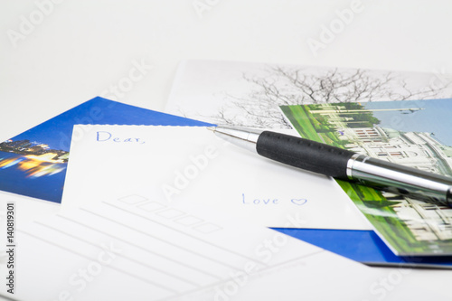Write postcard to someone
Envelope,postcard and pen isolated on white background. 