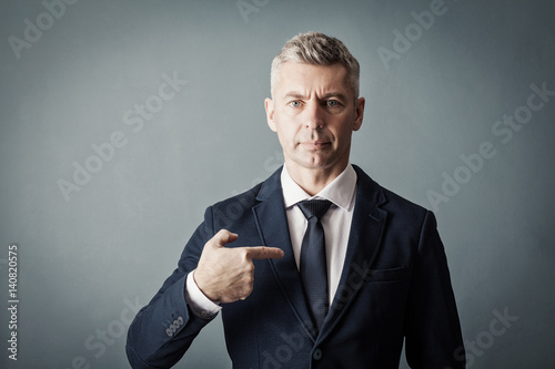 Businessman is pointing at himself photo