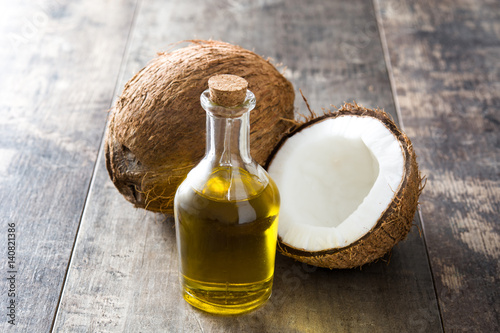 Coconut oil on wooden background 
