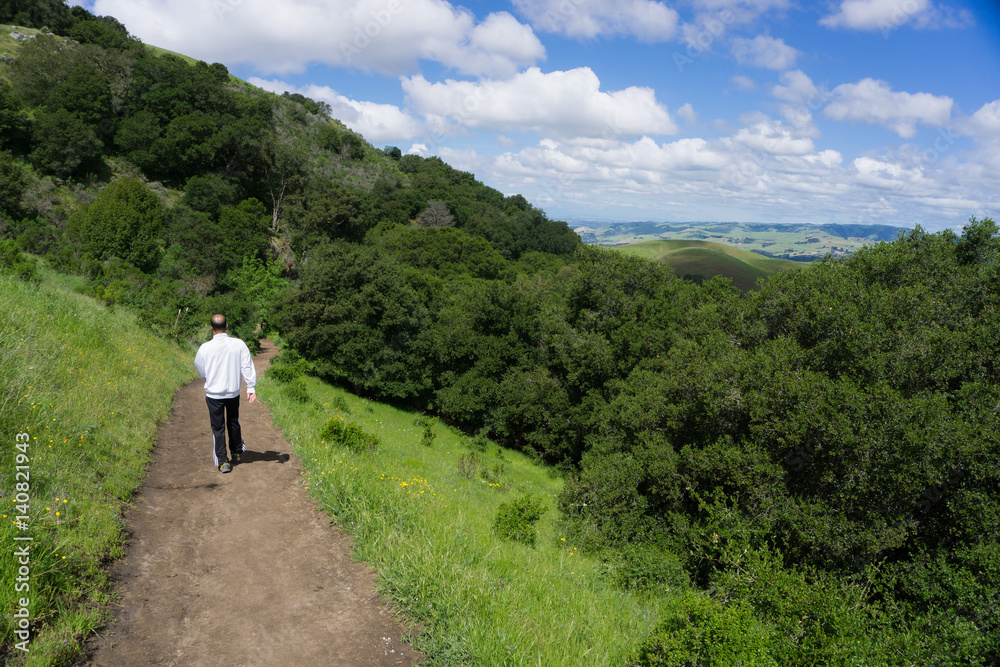 Hikers climb a California hill in beautiful spring conditions