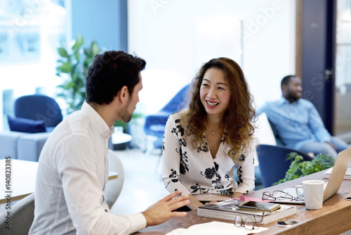 Chinese businesswoman in an office with caucasian male colleague photo