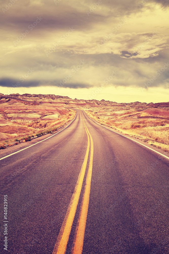 Color toned endless desert road before storm.