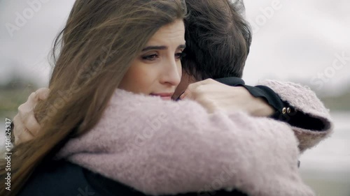 Woman hugging boyfriend feeling sad in love