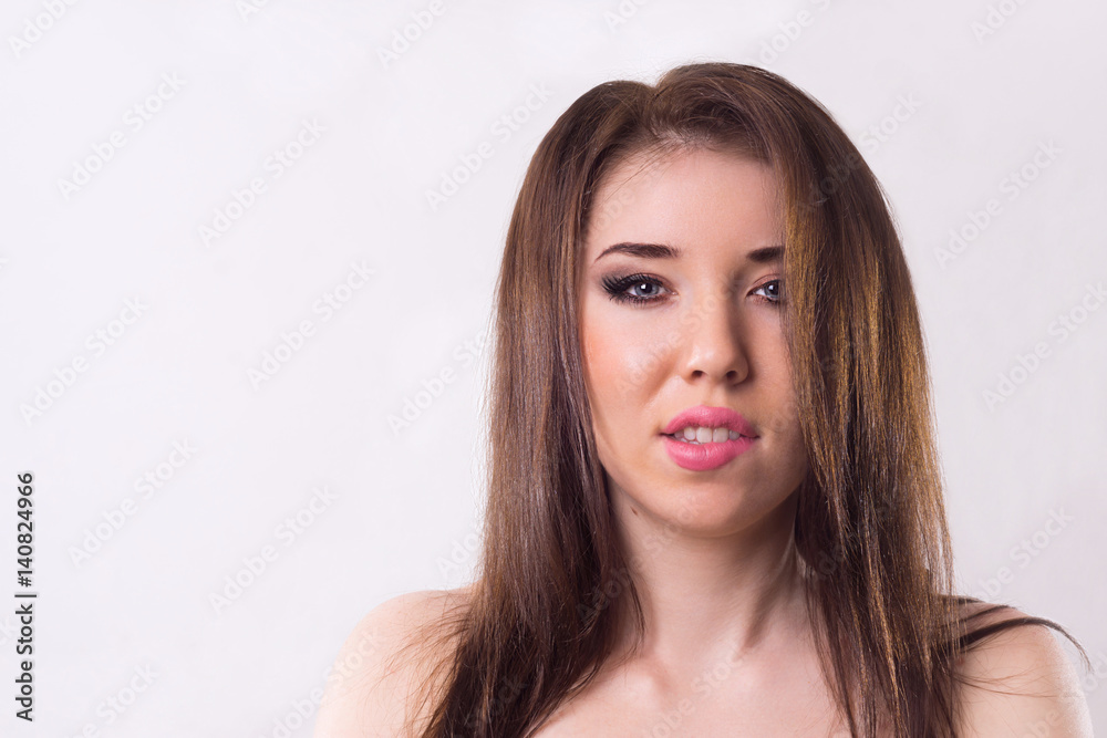 Portrait of a brunette on a light background. Portrait of a brunette on a light background.