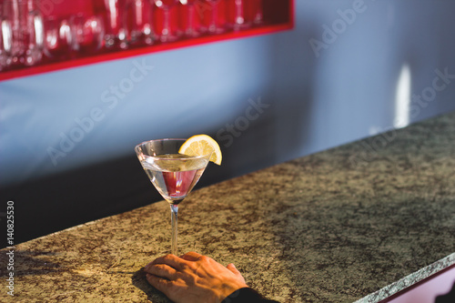 Martini at Bar with Lemon and Hand
