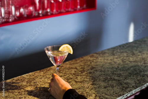 Martini at Bar with Lemon and Hand