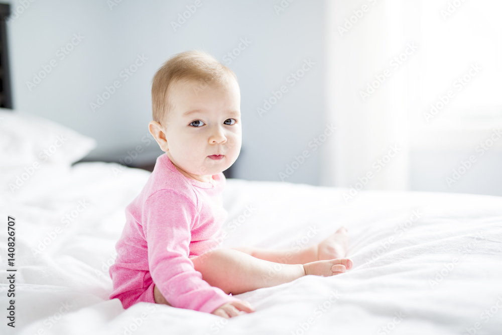 baby girl sit on white sheet baby girl sit on white sheet