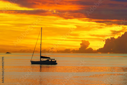 Sunset in sea and sailing yacht silhouette with beautiful landscape of Caribbean, Santa Lucia island 