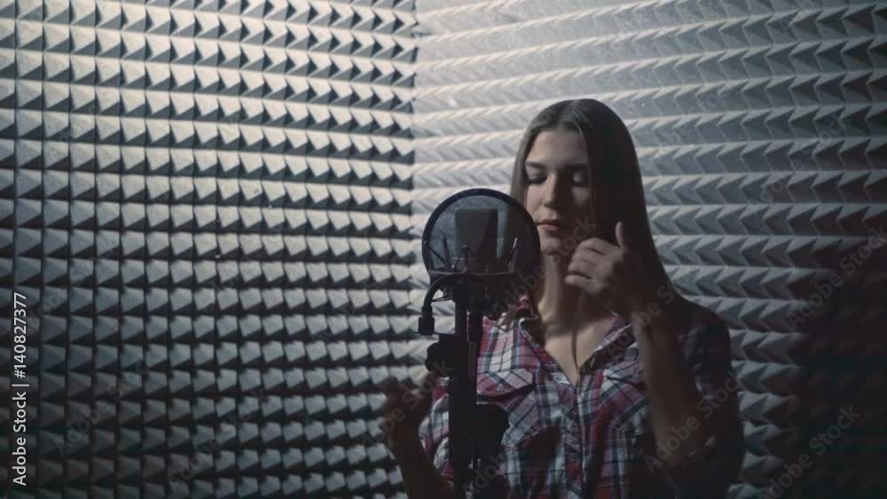 Attractive singing girl in recording studio