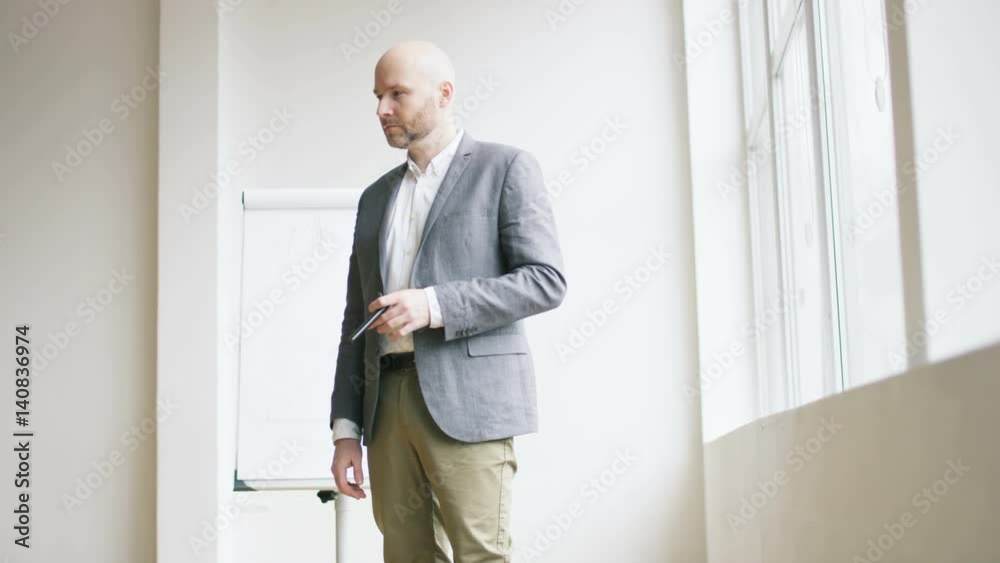Bald Businessman Playing With a Marker Bald Businessman Playing With a Marker