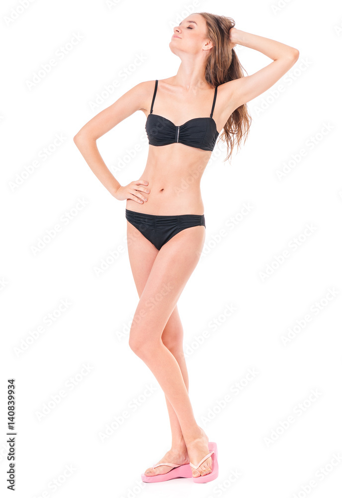 Sexy young woman posing in a black bikini, isolated on white background Sexy young woman posing in a black bikini, isolated on white background