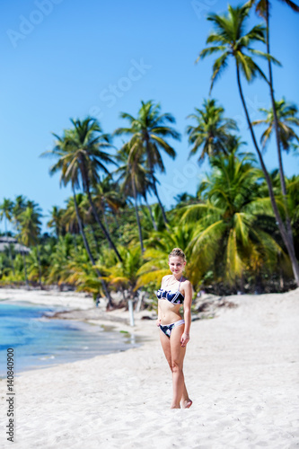 happy young girl model on the empty tropical beach