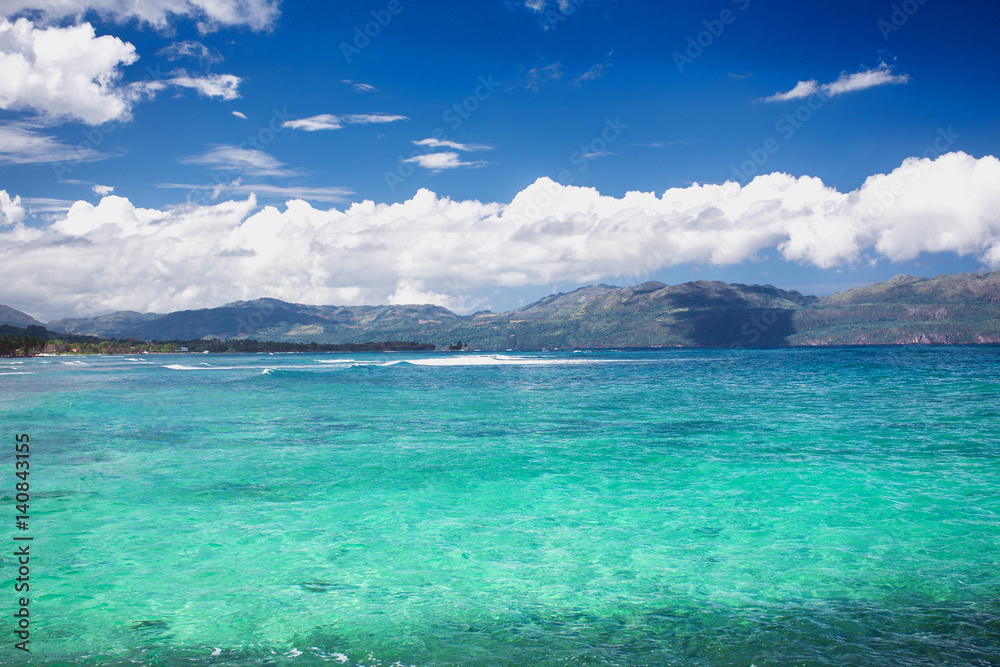 Caribbean sea surface summer wave background. Exotic water landscape with clouds on horizon. Natural tropical water paradise. Dominican Republic nature relax. Travel tropical island resort. Ocean natu