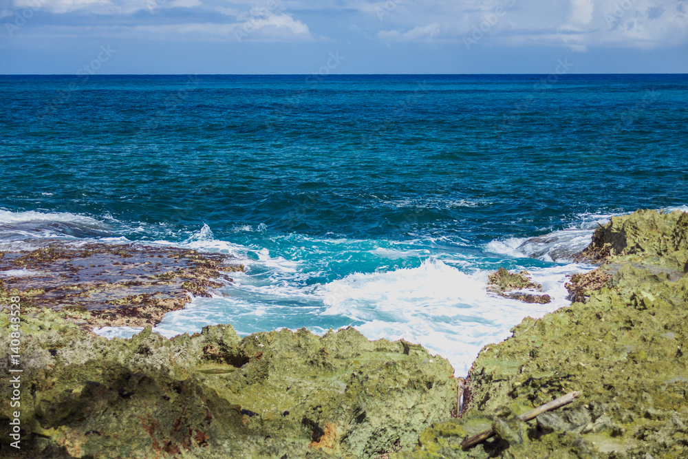 Foaming stormy sea and rocky shore in sunny weather Foaming stormy sea and rocky shore in sunny weather