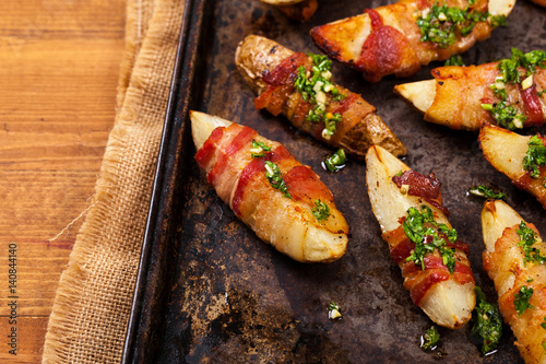 Bacon Wrapped Potatoes Wedges with Parsley Garlic Pesto Sauce. Selective focus.